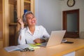 Corporate job lifestyle portrait of happy and successful attractive middle aged Asian woman working at office laptop computer desk Royalty Free Stock Photo