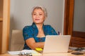 Corporate job lifestyle portrait of happy and successful attractive middle aged Asian woman working at office laptop computer desk Royalty Free Stock Photo