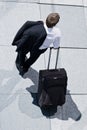 Corporate Man With Rolling Luggage Royalty Free Stock Photo