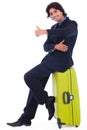 Corporate man sitting above the luggage Royalty Free Stock Photo