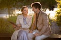 Corporate mature man and woman sitting at park, talking business Royalty Free Stock Photo