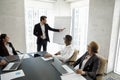 Corporate mentor, coach teaching interns at modern office meeting workspace