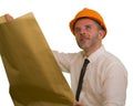 Corporate portrait of attractive and successful industrial engineer or contractor man in working hardhat holding blueprint Royalty Free Stock Photo