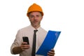 Corporate portrait of attractive and successful industrial engineer or contractor man in working hardhat smiling happy holding Royalty Free Stock Photo