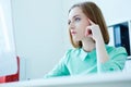 Corporate portrait of young business woman sitting at office chair working at desktop computer. Royalty Free Stock Photo