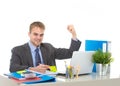 Corporate portrait of young attractive businessman gesturing and celebrating business success excited