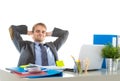 Corporate portrait of young attractive businessman leaning back on his chair relaxed and smiling happy Royalty Free Stock Photo