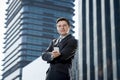 Corporate portrait of young attractive businessman with mobile phone outdoors Royalty Free Stock Photo