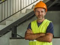 Corporate portrait of young attractive and happy builder man or constructor posing confident smiling wearing building helmet and Royalty Free Stock Photo