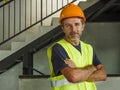 Corporate portrait of young attractive and happy builder man or constructor posing confident smiling wearing building helmet and Royalty Free Stock Photo