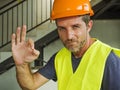Corporate portrait of young attractive and happy builder man or constructor posing confident smiling wearing building helmet and Royalty Free Stock Photo
