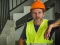Corporate portrait of young attractive and happy builder man or constructor posing confident smiling wearing building helmet and Royalty Free Stock Photo