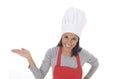 Corporate portrait of young attractive hispanic home cook woman in red apron posing happy and smiling isolated Royalty Free Stock Photo