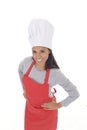 Corporate portrait of young attractive hispanic home cook woman in red apron posing happy and smiling isolated Royalty Free Stock Photo