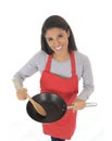 Corporate portrait of young attractive hispanic home cook woman in red apron posing happy and smiling isolated Royalty Free Stock Photo