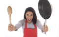 Corporate portrait of young attractive hispanic home cook woman in red apron posing happy and smiling isolated Royalty Free Stock Photo