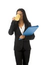 Corporate portrait young attractive latin businesswoman happy holding folder and coffee Royalty Free Stock Photo