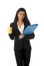 Corporate portrait young attractive latin businesswoman happy holding folder and coffee Royalty Free Stock Photo