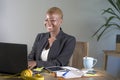 Corporate portrait of young happy and successful black afro American business woman working at modern office smiling cheerful havi Royalty Free Stock Photo