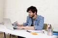 Corporate portrait young hispanic attractive hipster businessman working with computer modern home office