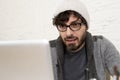 Corporate portrait young hispanic attractive hipster businessman working with computer modern home office Royalty Free Stock Photo