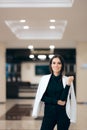 Elegant Businesswoman Casually Wearing Jacket on Shoulders