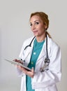 Corporate staff portrait of happy woman md emergency doctor or nurse posing smiling cheerful with stethoscope using digital tablet Royalty Free Stock Photo