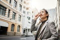 Corporate woman in city, travel and commute to work with buildings, motion blur and waiting for taxi cab. Professional Royalty Free Stock Photo