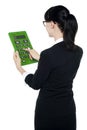 Corporate woman using green calculator Royalty Free Stock Photo