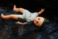 Dead doll floating in water Royalty Free Stock Photo