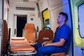 Corpsman in uniform sits inside the ambulance car