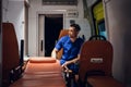 Corpsman sitting in an ambulance car and looking away