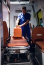 Corpsman stands with medical bag in the ambulance car