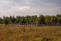 A corral for animals in a green meadow among trees. Small family farm Royalty Free Stock Photo