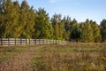 A corral for animals in a green meadow among trees. Small family farm Royalty Free Stock Photo