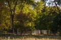 A corral for animals in a green meadow among trees. Small family farm Royalty Free Stock Photo