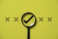 Correct sign mark inside magnifier glass among cross mark for focusing approve and reject business project proposal concept Royalty Free Stock Photo