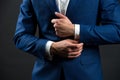 Correct sleeve length. Every detail matters. Jacket perfect fit. Business style formal dress code. Male hands adjusting