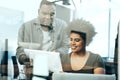 Is this correct. two young businesspeople looking at paperwork together in the office. Royalty Free Stock Photo