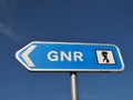 GNR police direction sign in front of blue sky in Portugal