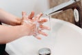 Caucasian woman washing and cleaning hands and fingers with soap and water