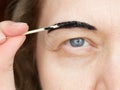 Correction of eyebrows and modeling at home, eyebrow coloring henna tattooing, permanent makeup closeup Royalty Free Stock Photo