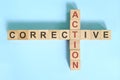 Corrective action business concept. Wooden blocks crossword puzzle flat lay. Royalty Free Stock Photo