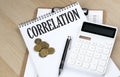 CORRELATION COEFFICIENT text with chart and calculator and coins , business concept Royalty Free Stock Photo
