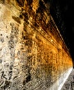 Corridor with ancient wallengravings of the ruins of Angkor in Cambodia