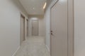 Corridor in beige stylish Interior design of the apartment. Design in beige tones. Doors in the color of the walls Royalty Free Stock Photo