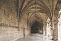 Corridor of the cloister in the Jeronimos Monastery with arched stone interior in Lisbon, Portugal