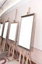 Corridor with blank frames on painting easel