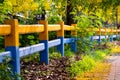 Colorful farm fences and yellow flowers in the flowering season. Royalty Free Stock Photo