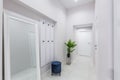 Corridor interior, in an apartment with white walls and bright doors Royalty Free Stock Photo